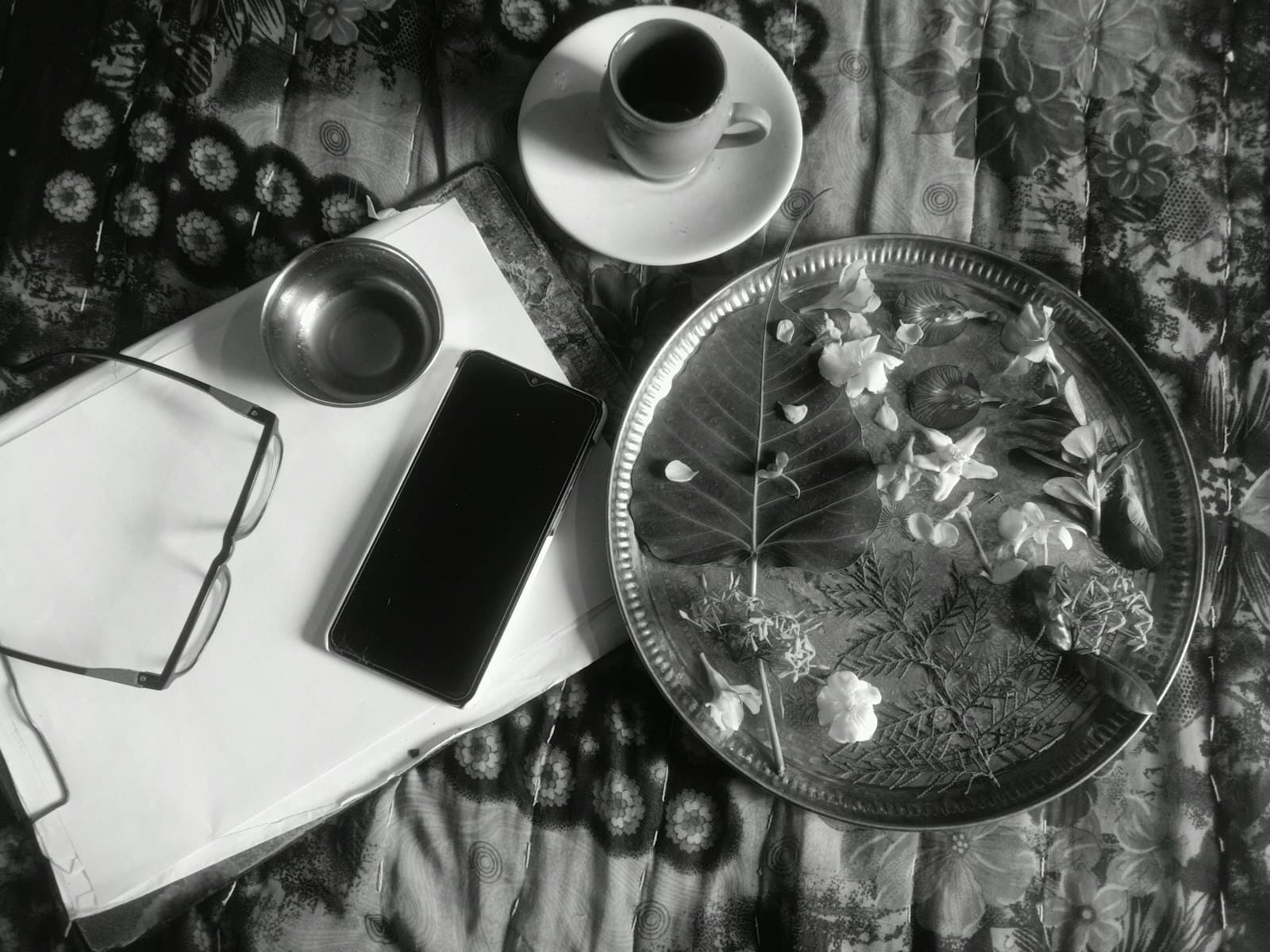 Overhead view of breakfast items and a phone on a bed