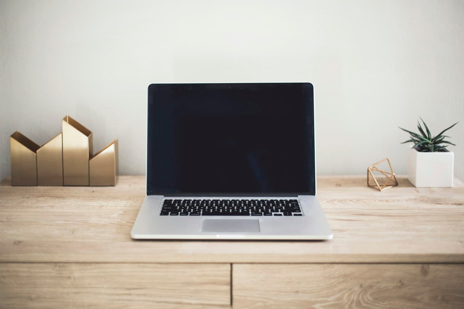 A MacBook Pro on top of a brown table